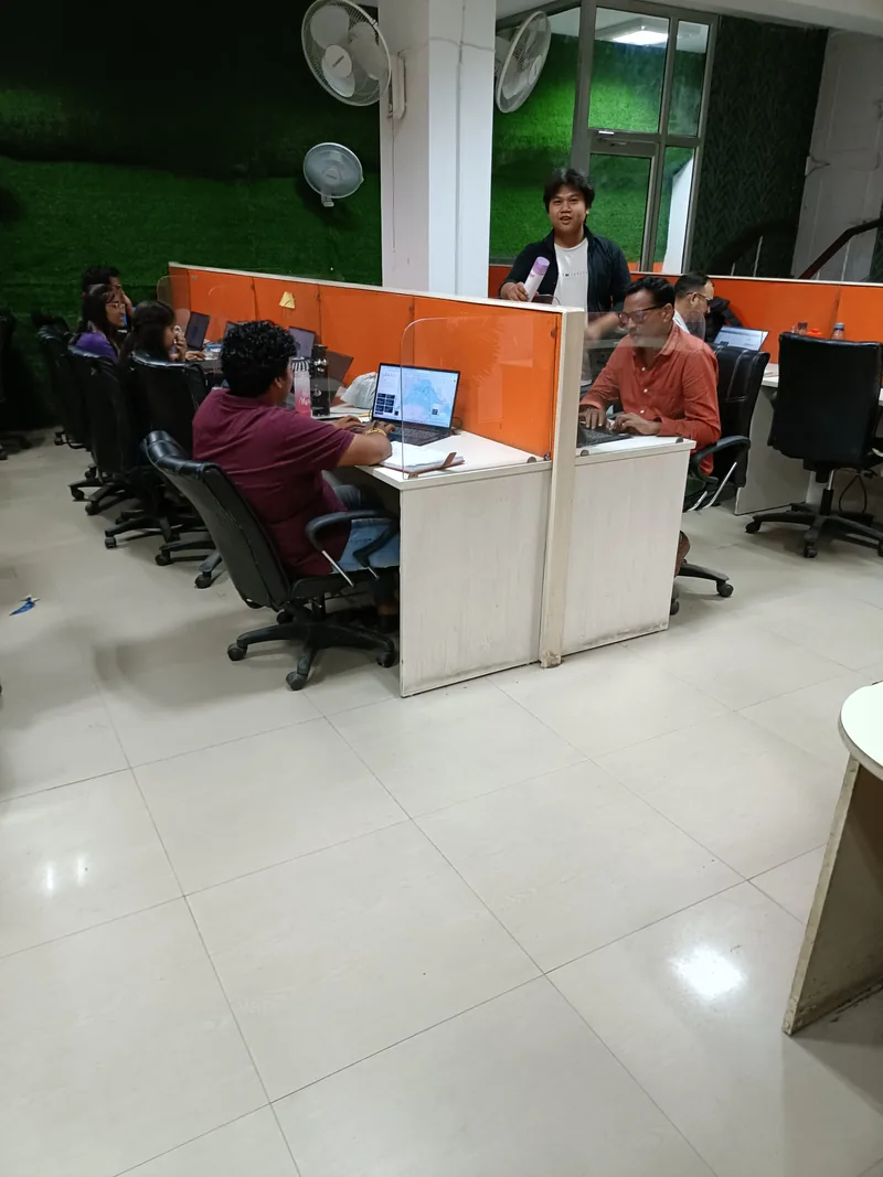 Company-submitted workspace photo showing people at shared desks